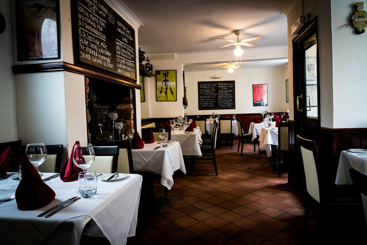 Tables set for dinner beneath the specials blackboard at Burrs.